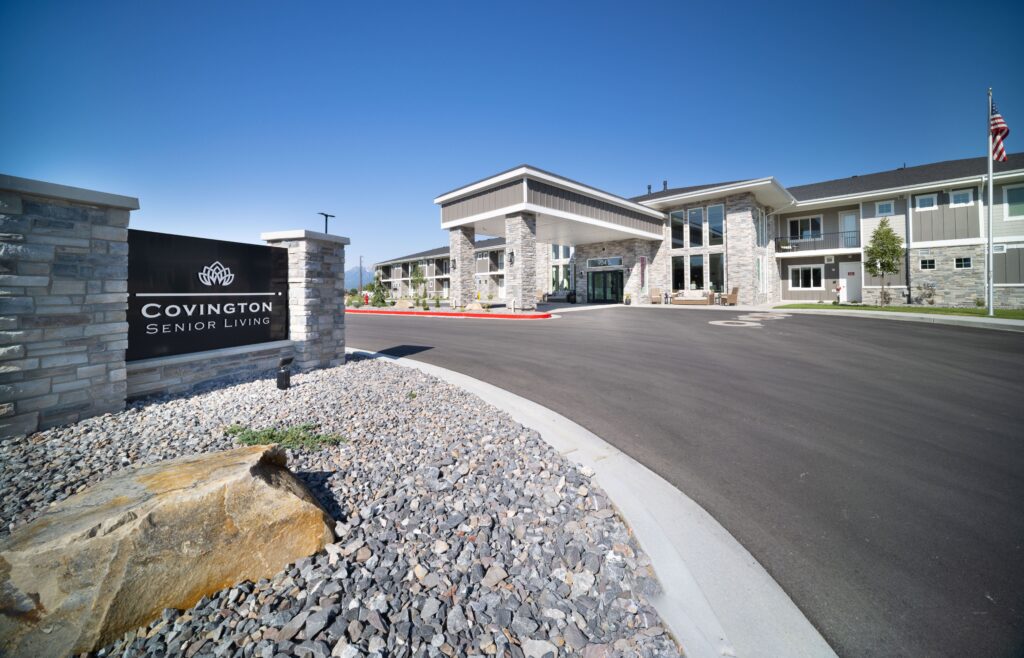Assisted living in Heber exterior at Covington Senior Living with covered entrance, stone facade, and community sign.